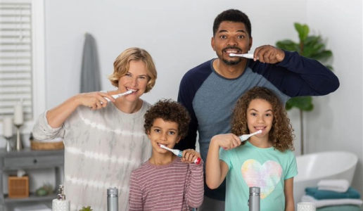 Family brushing their teeth with Spinbrush electric toothbrushes.